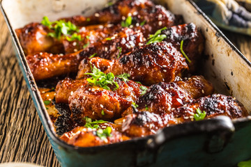 Grilled roasted and barbecue chicken legs in pan