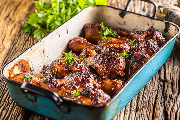 Grilled roasted and barbecue chicken legs in pan