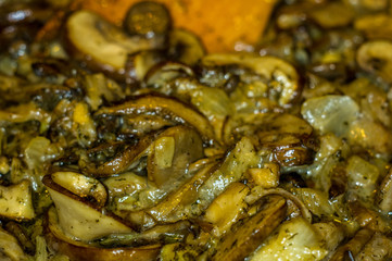 fried with onions and spices Royal mushrooms champignons in a frying pan
