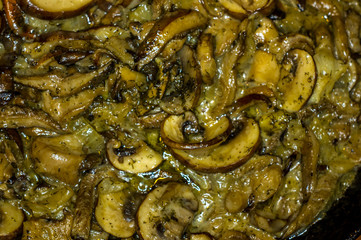 fried with onions and spices Royal mushrooms champignons in a frying pan