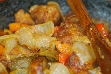 Roast meat, onions, carrots and spices, boiling in oil