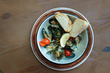 Dish with mussels. Top view of delicious yummy seafood dish with big mussels in creamy sauce