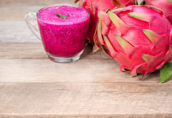 Fresh red dragon (pitaya) fruit juice in glass mug. Close up 