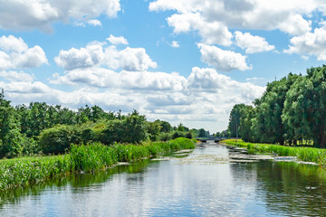 Fototapeta na wymiar Views of a ditch with beautiful Dutch skies