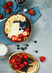 bowl of cottage cheese with berries, bananas and sour cream
