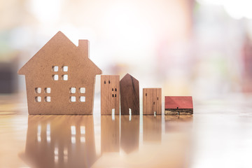 Wood house model on wood table , a symbol for construction , ecology, loan, mortgage, property or...