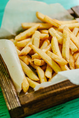 French fries on a wooden board