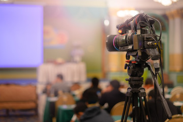 Video camera taking live video streaming with people working background at meeting room.