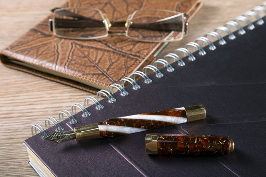 fountain pens and diaries with leather cover business still life