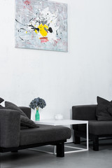 paint on wall, black modern armchairs in living room