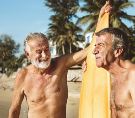 Mature surfers at beach