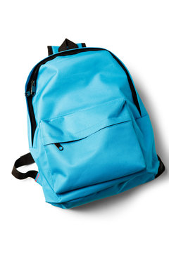 Top view of blue school backpack on white background.
