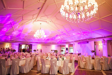 photo interior is a refined banquet hall with purple and pink light - Powered by Adobe