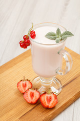 Delicious strawberry yogurt with mint leaves in glass