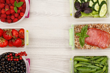 Plastic meal prep containers with black currant, strawberries, raspberries, green peas, boiled buckwheat porridge and slices of meat, fresh cucumbers and salad
