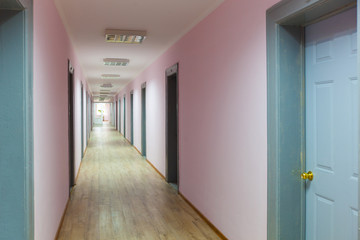 photo of empty corridor with many doors
