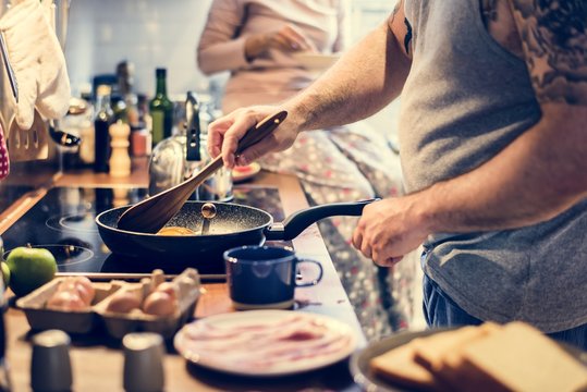 Man Cooking Breakfast In The Kitchen