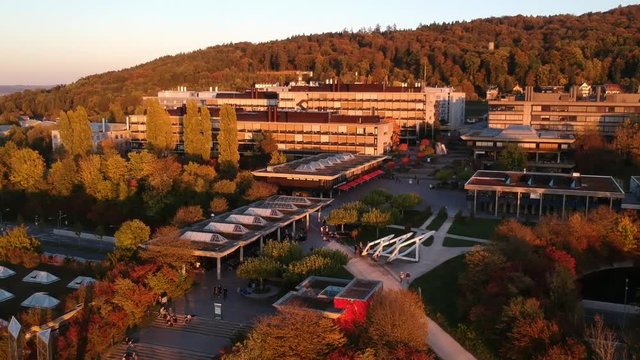 drone slowly reveals University of Z&uuml;rich Irchel campus while moving forward and climbing at sunset