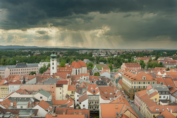 Fototapeta na wymiar view over the roof tops of northern Budweis and the dominican monastery under a dark cloudy sky