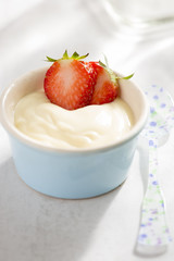 Vanilla custard dessert with fresh strawberries