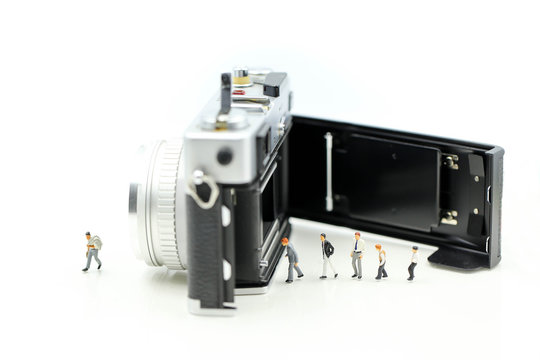 Miniature people : Businessman with film camera,Digital business concept.