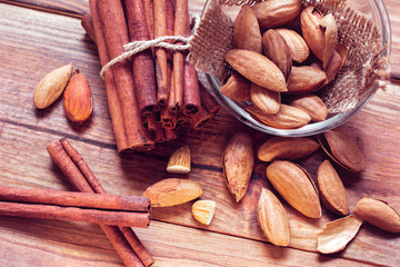 almonds and cinnamon on a wooden background