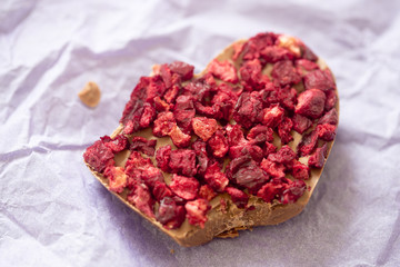 Chocolate heart with dried cherries bite taken