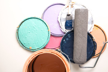 Paint can and lids with roller and brush