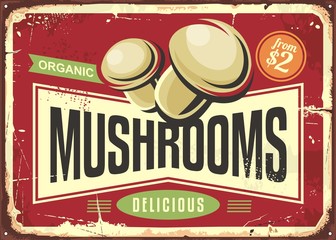 Vintage tin sign with fresh organic mushrooms on red background. Green food vegan concept for vegetarian restaurant decoration.
