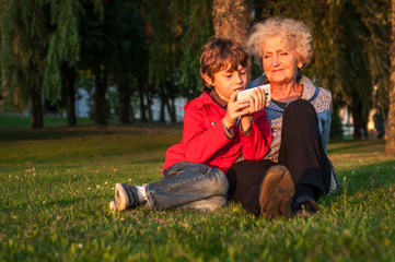 Grandmother and grandson are photographed on the phone