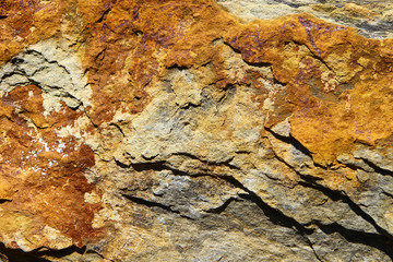 Rusty brown stone surface texture with cracks. Sea limestone.
