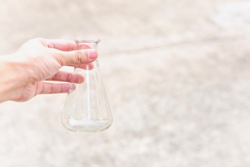 Hand Holding an Erlenmeyer Flask for Laboratory Test