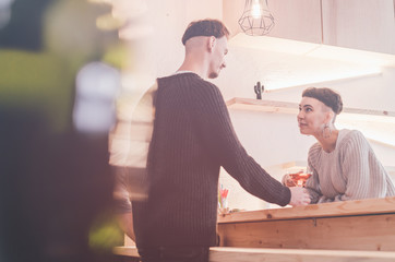 Handsome bartender flirting to woman in a classy bar