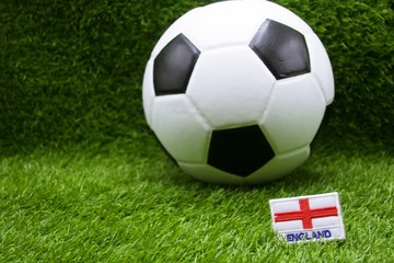 England Flag with football are on green grass