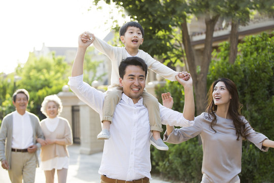 Happy Chinese Family Strolling Outside