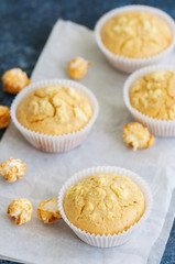 Homemade cornbread muffins on a blue stone background.