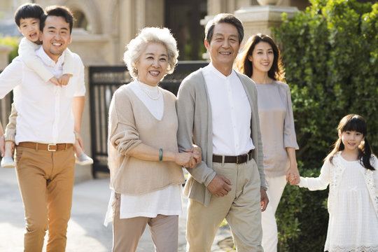 Happy Chinese Family Strolling Outside