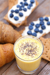 Mango smoothie vertical rustic flat lay composition.