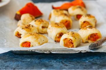 Puff pastry rolls with pumpkin and cheese filling. Close up.