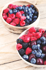 Various beautiful summer berries covered by water drops.