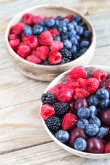 Various beautiful summer berries covered by water drops.