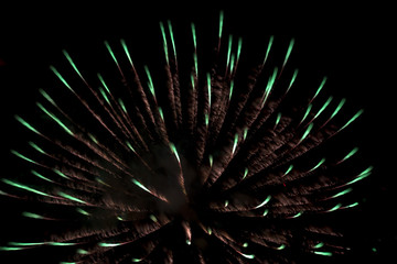 Night burst of beautiful firework celebration with colorful glow, glitter, pattern and motion