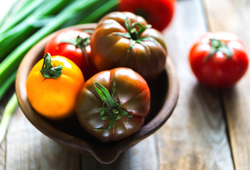 Home-grown various tomatoes on vintage wooden boards.