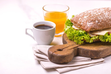 Chiabatta sandwich, coffee and orange juice. Breakfast. Selective focus