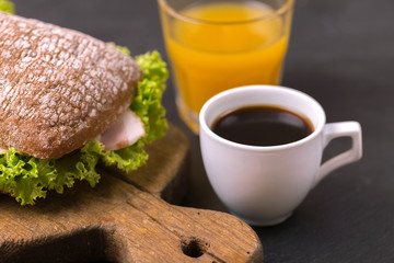 Chiabatta sandwich, coffee and orange juice. Breakfast. Selective focus