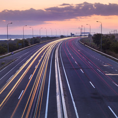 Fototapeta premium a lot of car trails on the highway in beautiful summer evening