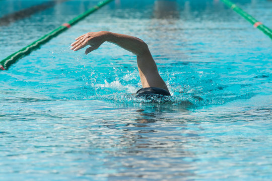swimmer in lane pool, man in water