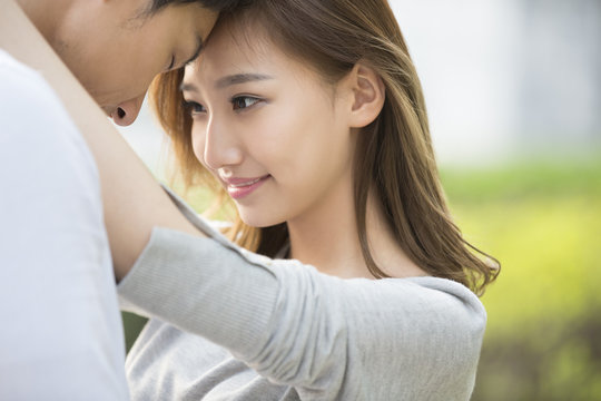 Close up of young couple embracing each other outdoors