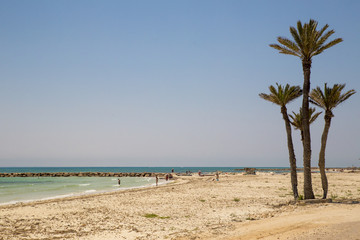 Soft blue ocean wave on sandy beach. Bottom. White sand on the beach with turquoise water in Djerba, Tunisia.