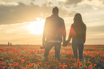 Love at sunset amid the poppy field